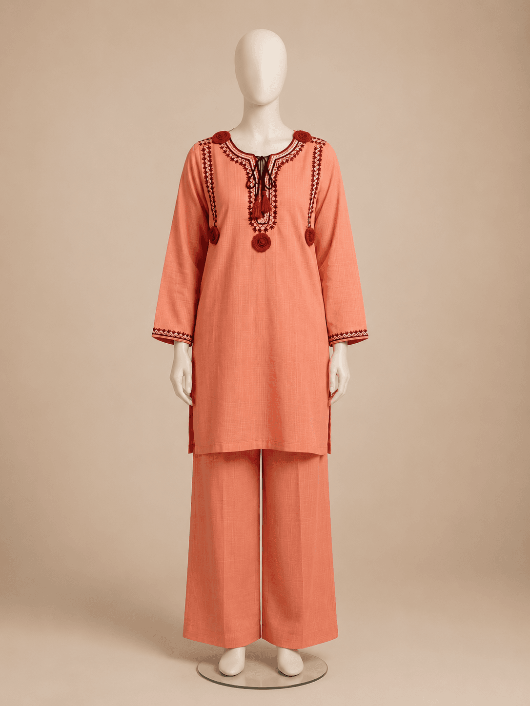 Gulnar coral embroidered kurta set, front view with red neckline embroidery and tasselled tie