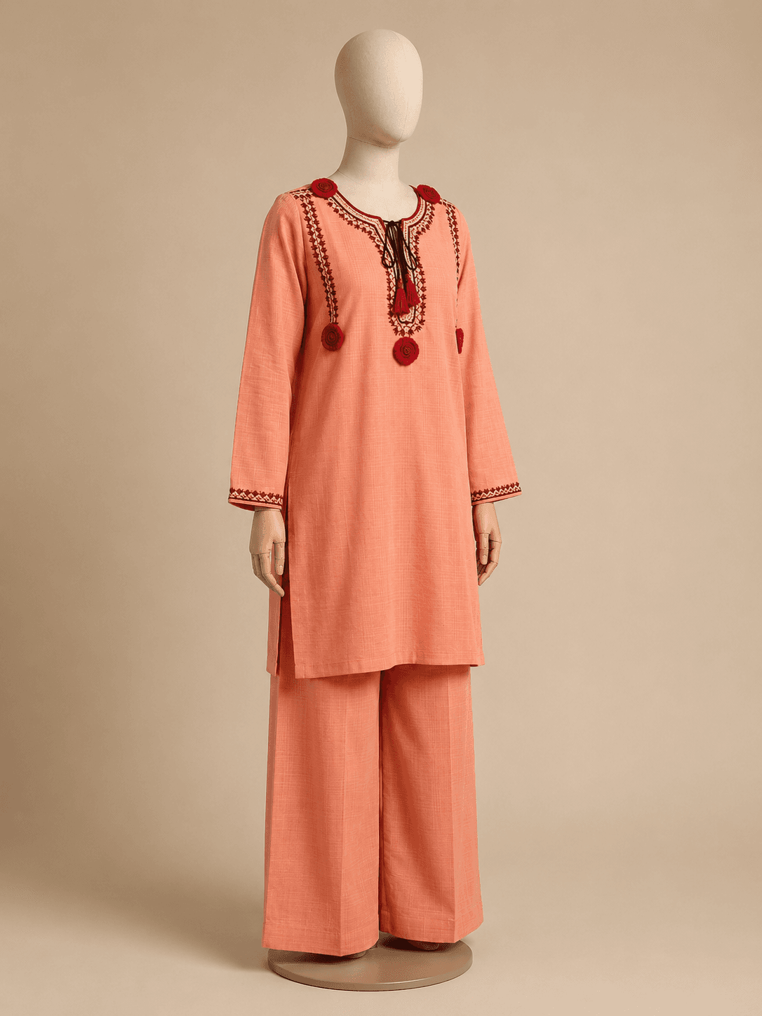 Gulnar coral kurta set shown at a three-quarter angle