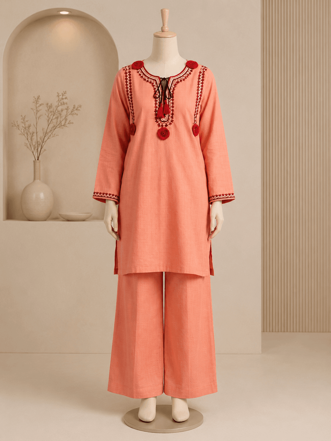 Coral embroidered kurta set styled in a warm festive interior